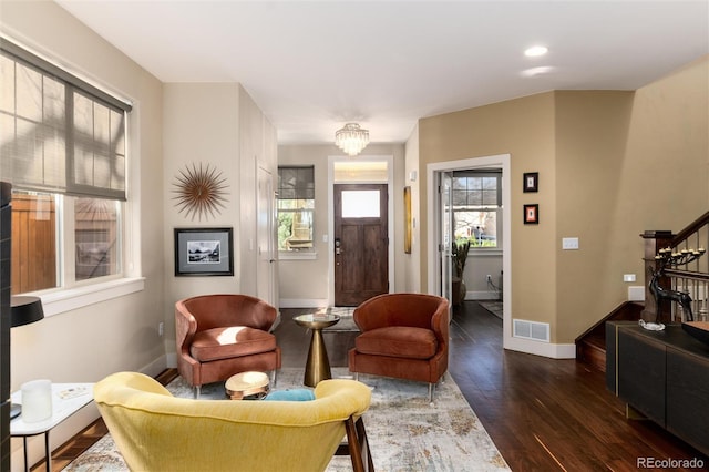 interior space featuring visible vents, baseboards, dark wood-style floors, and stairway