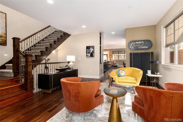 living area featuring recessed lighting, stairs, baseboards, and wood finished floors