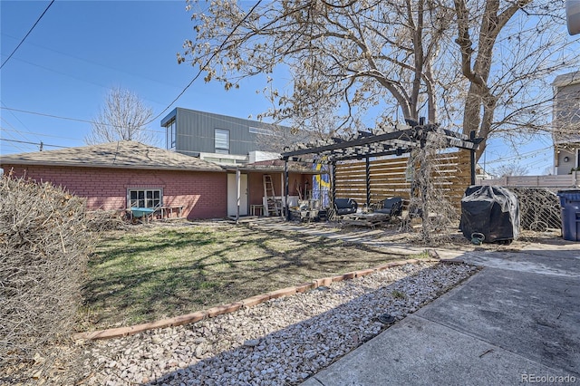 back of house with a yard, a pergola, and a patio area