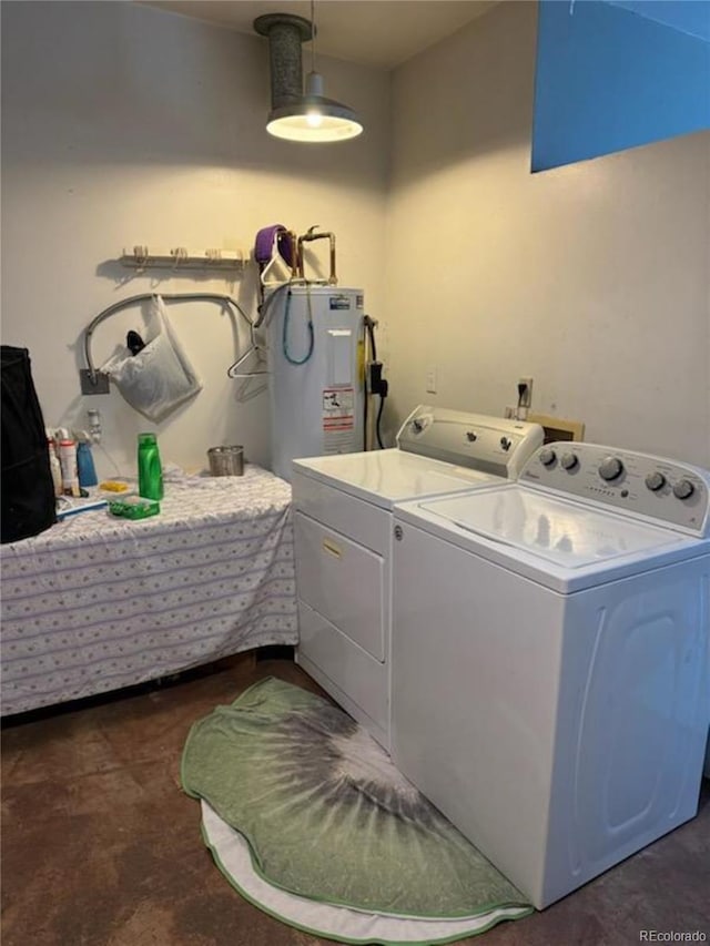 clothes washing area with water heater and washing machine and dryer