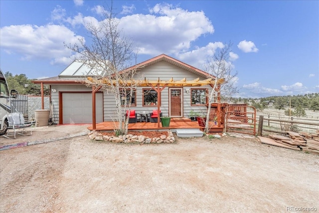3404 Green Mountain Dr, Livermore, CO 80536 - view of front of property featuring a deck, an attached garage, fence, and dirt driveway