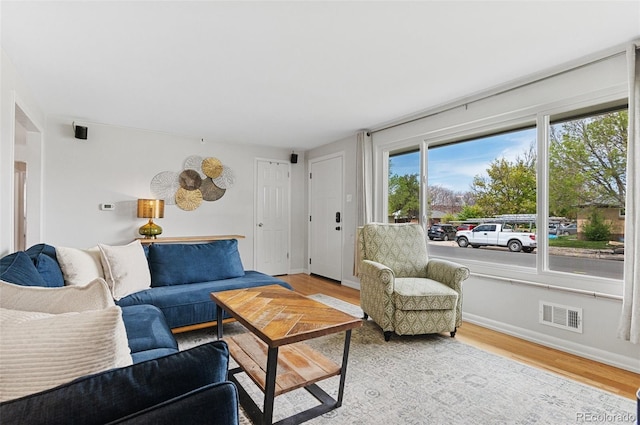 living room with wood finished floors and baseboards