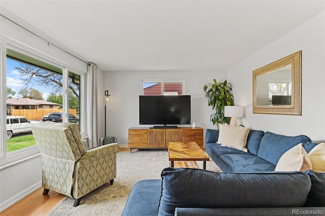 living room with light wood-type flooring and baseboards