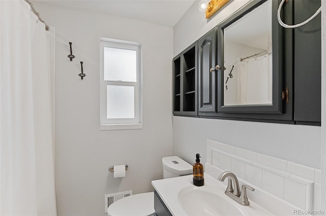 bathroom featuring toilet and vanity