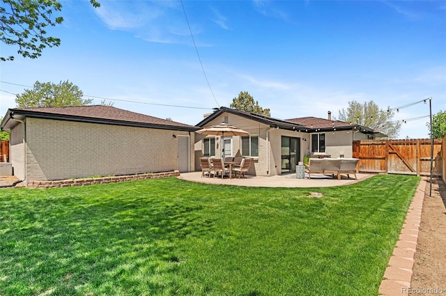 back of property with brick siding and a patio