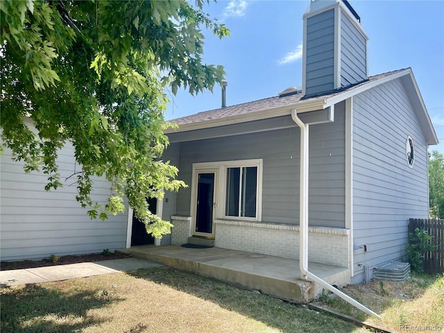 7240 W Yale Ave, Denver, CO 80227 - rear view of property with a chimney, roof with shingles, and brick siding