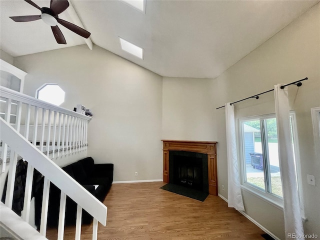 7240 W Yale Ave, Denver, CO 80227 - living area with a fireplace with flush hearth, wood finished floors, and a ceiling fan