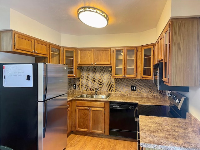 7240 W Yale Ave, Denver, CO 80227 - kitchen featuring freestanding refrigerator, dishwasher, electric stove, brown cabinets, and tasteful backsplash