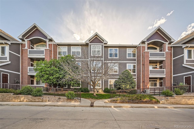 14221 E 1st Dr Unit 303, Aurora, CO 80011 - view of front of house featuring brick siding