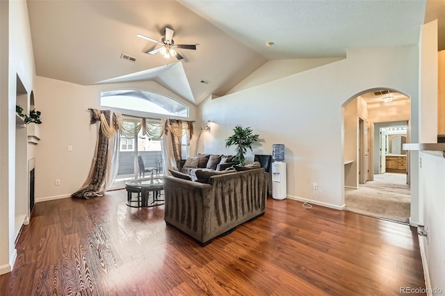 14221 E 1st Dr Unit 303, Aurora, CO 80011 - living area with arched walkways, ceiling fan, a fireplace, vaulted ceiling, and wood finished floors