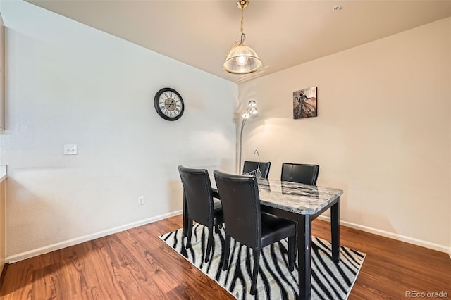 14221 E 1st Dr Unit 303, Aurora, CO 80011 - dining area featuring baseboards and wood finished floors