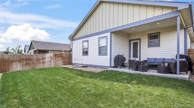 1086 Johnson St, Wiggins, CO 80654 - back of property featuring an outdoor living space, board and batten siding, and a patio area
