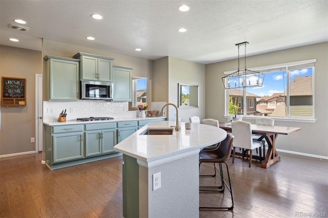 20855 Park Hollow Dr, Parker, CO 80138 - kitchen with a sink, appliances with stainless steel finishes, baseboards, light countertops, and decorative backsplash
