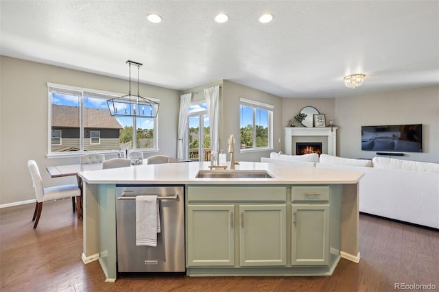 20855 Park Hollow Dr, Parker, CO 80138 - kitchen with a sink, open floor plan, light countertops, a kitchen island with sink, and a lit fireplace
