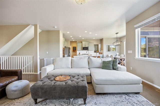 20855 Park Hollow Dr, Parker, CO 80138 - living room featuring baseboards, recessed lighting, wood finished floors, and a chandelier