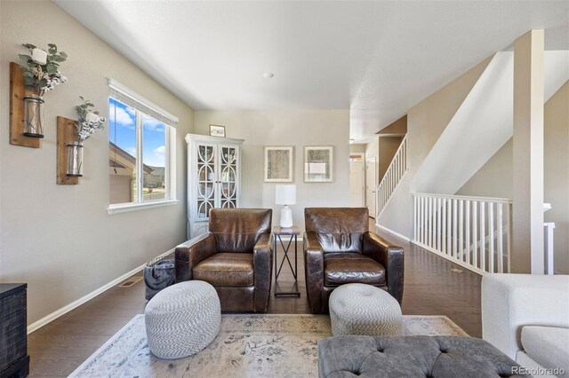 20855 Park Hollow Dr, Parker, CO 80138 - living area featuring baseboards, wood finished floors, and stairs