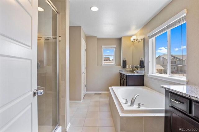 20855 Park Hollow Dr, Parker, CO 80138 - bathroom featuring a shower stall, a bath, vanity, baseboards, and tile patterned flooring