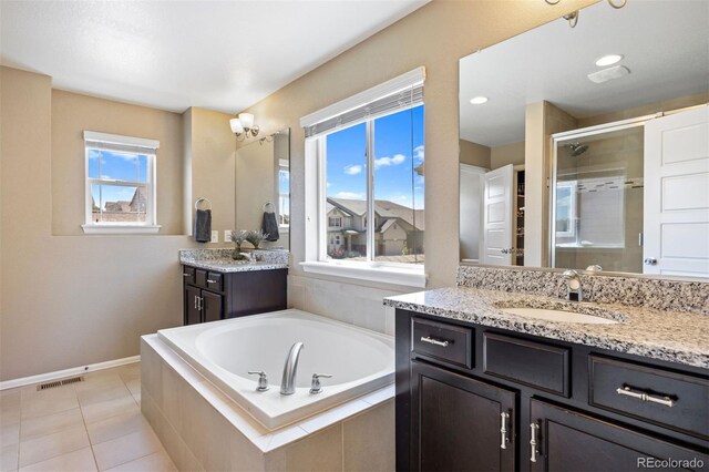20855 Park Hollow Dr, Parker, CO 80138 - full bath featuring a shower stall, a garden tub, two vanities, tile patterned floors, and baseboards