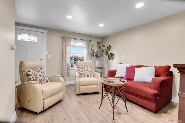 724 County Road 37, Brighton, CO 80603 - living area with baseboards, a textured ceiling, recessed lighting, and light wood-type flooring
