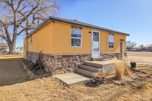 724 County Road 37, Brighton, CO 80603 - view of front of house featuring stone siding and stucco siding