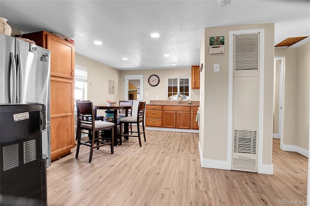724 County Road 37, Brighton, CO 80603 - dining room with baseboards, recessed lighting, a heating unit, and light wood finished floors