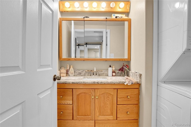 724 County Road 37, Brighton, CO 80603 - bathroom featuring vanity and stacked washer / drying machine