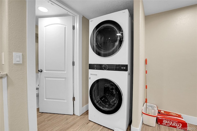 724 County Road 37, Brighton, CO 80603 - laundry area featuring light wood-style flooring, stacked washer / dryer, and laundry area