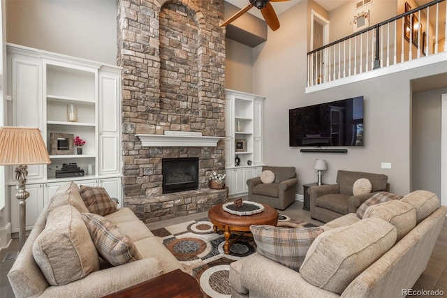 171 October Pl, Castle Rock, CO 80104 - living area featuring ceiling fan, a high ceiling, and a fireplace