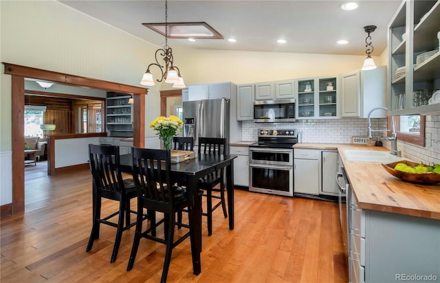 4805 S Blue Spruce Rd, Evergreen, CO 80439 - kitchen featuring stainless steel appliances, wood counters, backsplash, decorative light fixtures, and recessed lighting