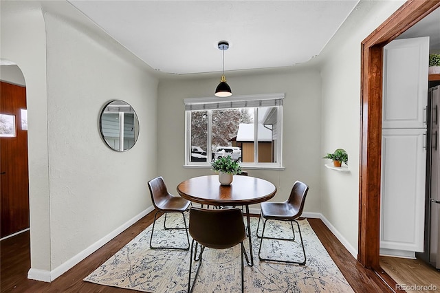 dining space featuring dark hardwood / wood-style flooring