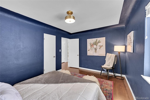 bedroom with hardwood / wood-style floors