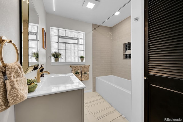 bathroom featuring vanity and tiled shower / bath combo