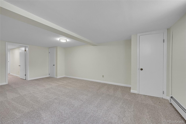 basement with a baseboard radiator and light carpet