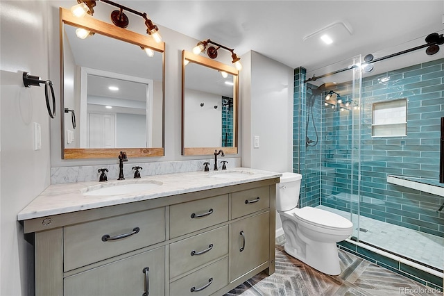 bathroom featuring vanity, toilet, and a shower with shower door