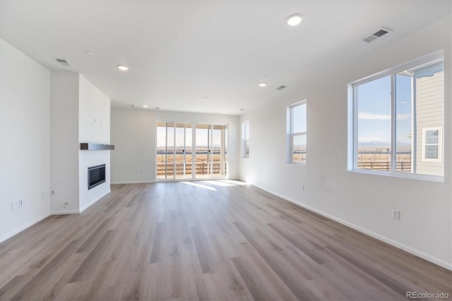 unfurnished living room featuring light hardwood / wood-style floors