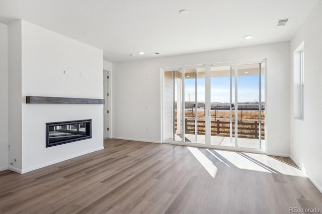 unfurnished living room featuring hardwood / wood-style floors