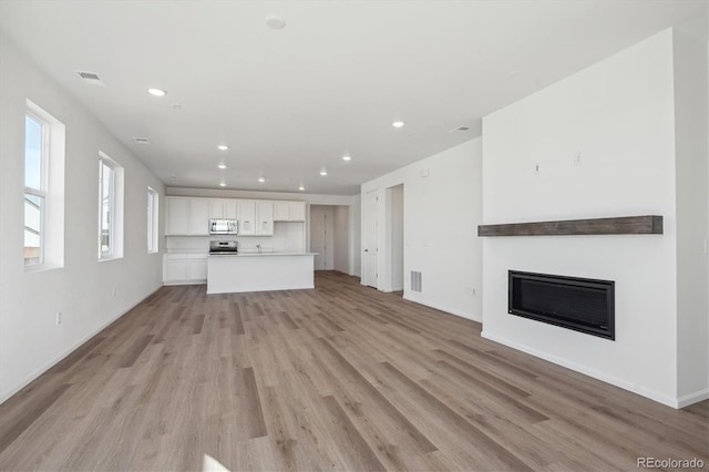 unfurnished living room featuring light hardwood / wood-style floors