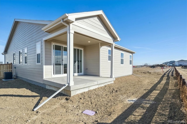 rear view of house with a patio and central AC unit