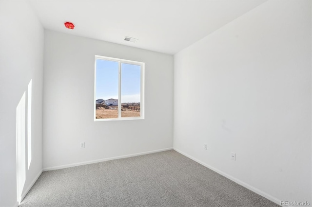 carpeted spare room featuring plenty of natural light