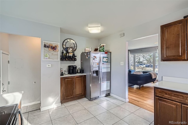 kitchen featuring appliances with stainless steel finishes and light tile patterned floors