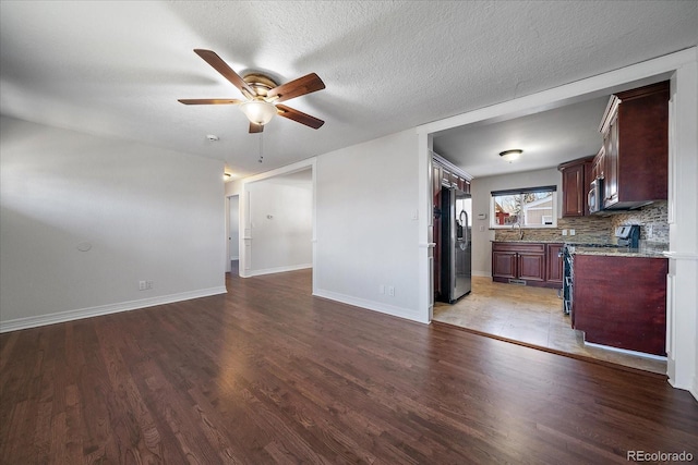 interior space featuring wood-type flooring, a textured ceiling, ceiling fan, and sink