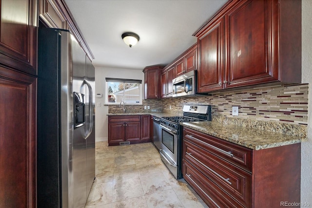 kitchen featuring sink, stainless steel appliances, tasteful backsplash, and stone countertops