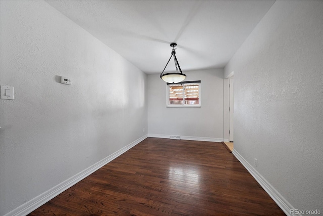 unfurnished dining area with dark hardwood / wood-style floors