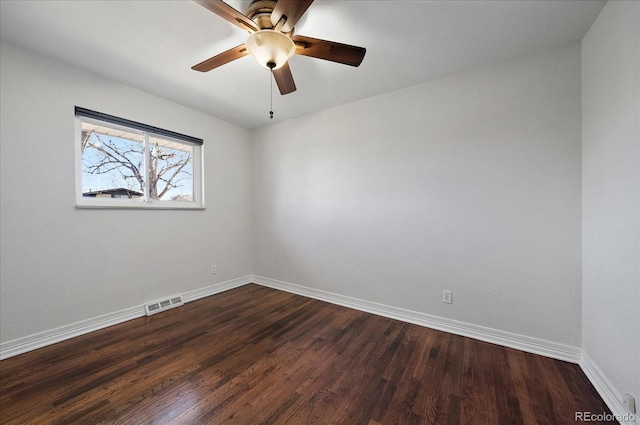 spare room with dark hardwood / wood-style floors and ceiling fan