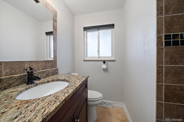 bathroom featuring backsplash, tile patterned flooring, vanity, and toilet