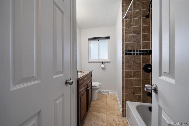 full bathroom featuring vanity, toilet, and tiled shower / bath combo