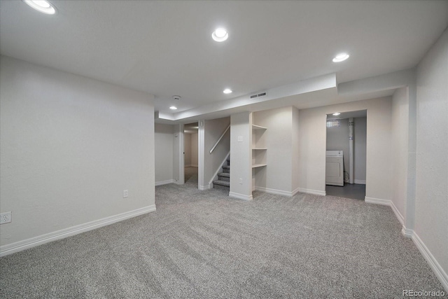 basement featuring carpet flooring and washer / clothes dryer