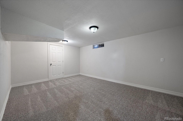 basement featuring carpet floors and a textured ceiling