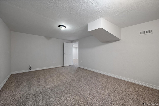 bonus room featuring carpet flooring and a textured ceiling