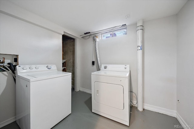 clothes washing area with washing machine and dryer